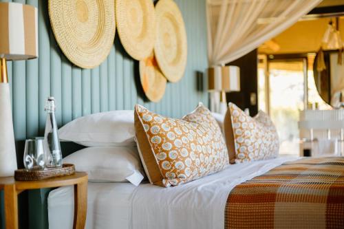 a bedroom with a bed with pillows on it at Horizon by Ongava in Okaukuejo
