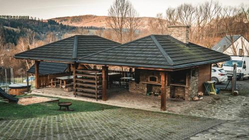 a pavilion with a roof on top of it at Jaworowa Osada in Brenna
