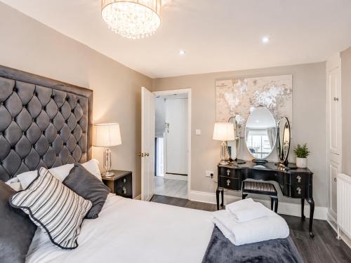 a bedroom with a large bed and a mirror at Hexham Town Centre, Market Place View in Hexham