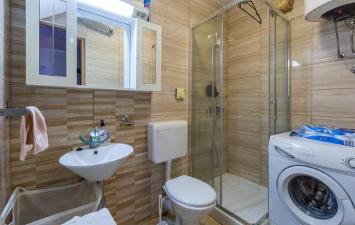 a bathroom with a toilet and a sink and a shower at Marija's House in Bale