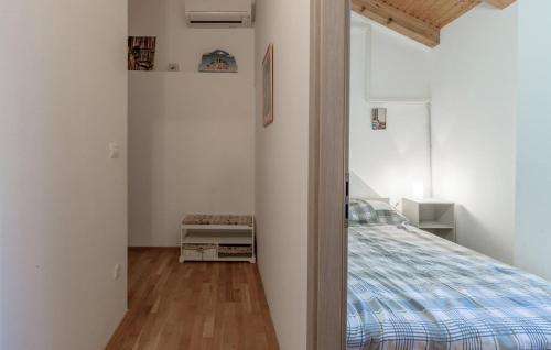 a bedroom with a bed in a white room at Marija's House in Bale