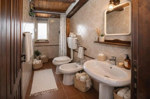 a bathroom with a sink and a toilet and a mirror at Seafront Iconic Lighthouse View Punta Secca in Punta Secca
