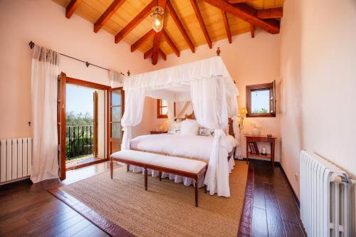 a bedroom with a white bed with a canopy at Villa Privada De Lujo Con Spa in Inca