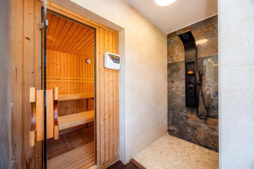 a sauna with a wooden door in a room at Villa Privada De Lujo Con Spa in Inca