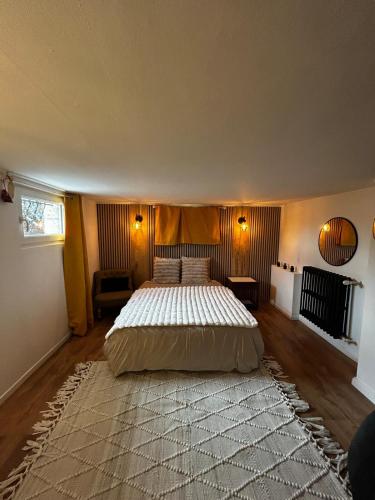 a bedroom with a large bed and a large rug at Pause confortable, escapade culturelle in Caen