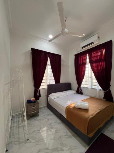 a bedroom with a bed with red curtains and a ladder at UZ Jerteh Inn in Jertih