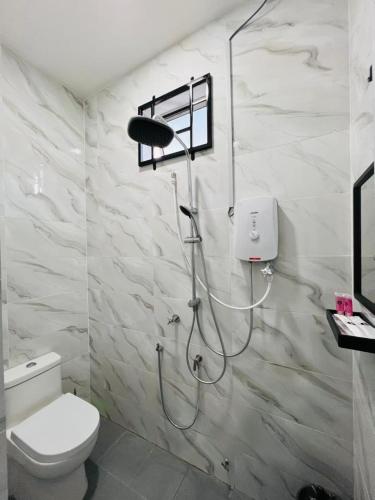 a shower in a bathroom with a toilet at UZ Jerteh Inn in Jertih