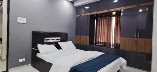 a bedroom with a large bed and a window at 2 BHK All AC Rooms Solapur Home Stay By Stay Nestura in Solapur
