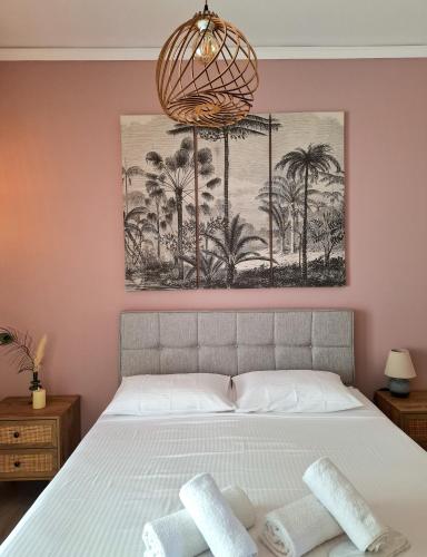a bedroom with a bed with two towels on it at Blue Sky Apartments Pythagorion in Pythagoreio