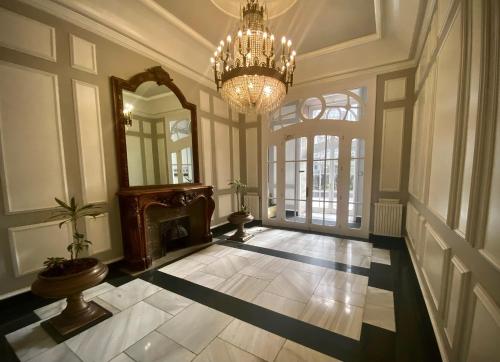 a large hallway with a chandelier and a fireplace at Edificio El Moderno, Vigo 1.902 in Vigo