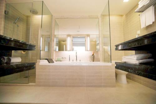 a large bathroom with a tub and a shower at Equatorial Ho Chi Minh City in Ho Chi Minh City