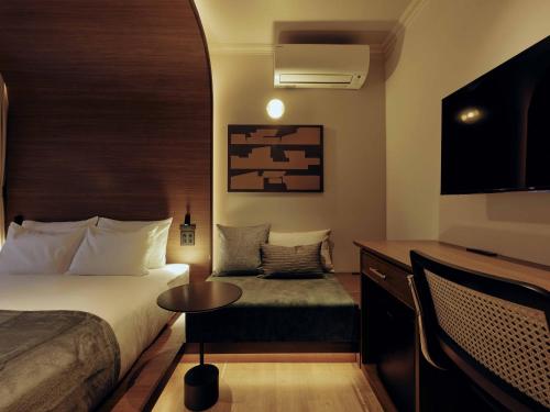 a hotel room with a bed and a small table at illi Hotels Lume Shibuya in Tokyo