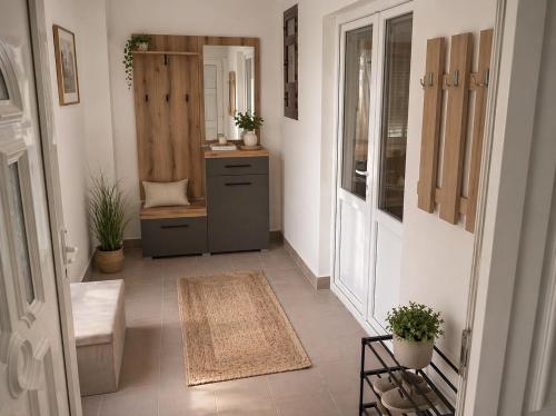 a hallway of a home with a toilet and a sink at Petrović Garden in Inđija