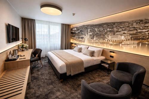 a hotel room with a bed and a desk and chairs at Hotel Bratislava in Bratislava