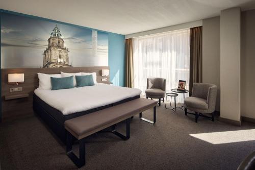 a hotel room with a bed and a large window at Van der Valk Hotel Groningen-Hoogkerk in Groningen