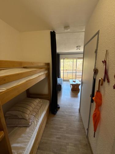 a room with two bunk beds and a hallway at Dove house in Barcelonnette