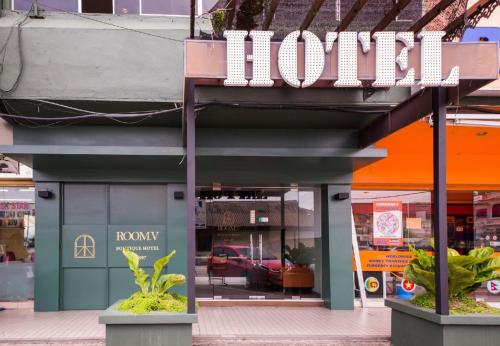 a hotel sign on the side of a building at Room V Jalan Jenang by SECOMS in Batu Pahat