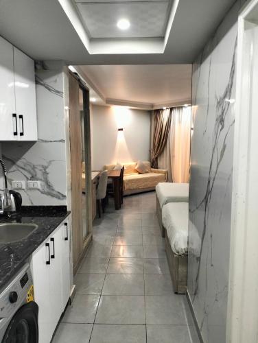a room with a bed and a kitchen with a sink at Scandic resort chalet in Hurghada