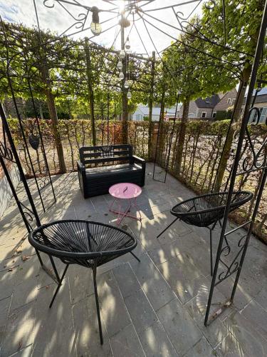 a patio with two chairs and a black couch at L'enjo'Leuze in Winée
