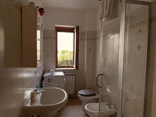 a bathroom with a sink and a toilet and a shower at Sperlonga Paradise Central House in Sperlonga