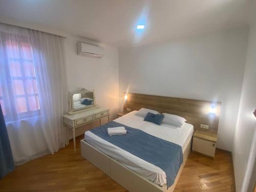 a bedroom with a large bed and a television at "Ламази"Домашняя гостиница in Kobuleti