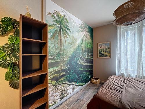 a bedroom with a palm tree mural on the wall at Expérience Balinaise à Amiens in Amiens