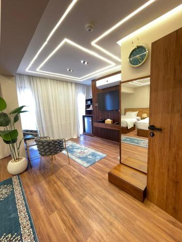a living room with a mirror and a bedroom at Sheraton Royal Sea View in Alexandria