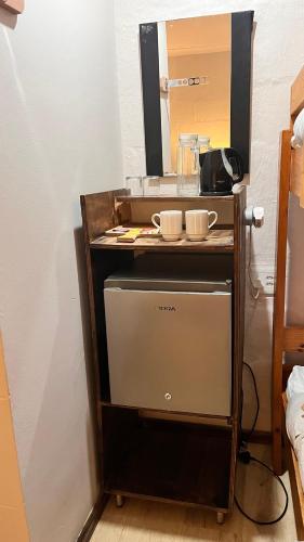 a food cart with two cups on top of it at Drakensberg Inkosana Lodge in Champagne Valley