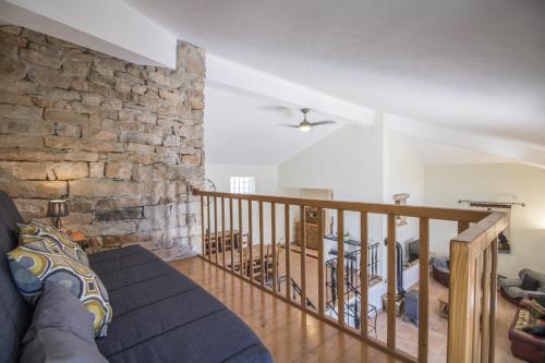 a living room with a couch and a stone wall at Villa Angel by Algarve Holidays in Loulé