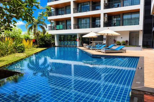 a swimming pool in front of a hotel at Kata Beach Pool View Condo - 400m from the Beach in Kata Beach
