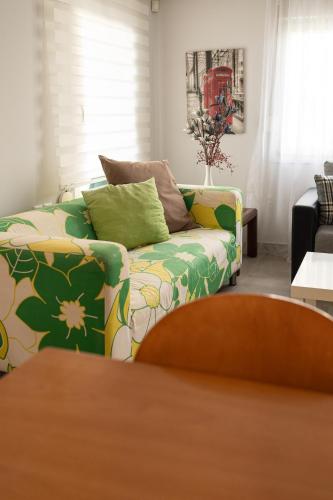 a living room with a couch and a table at Olympus & Sea Harmony in Katerini