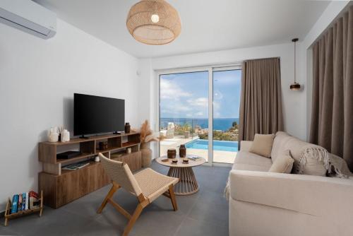a living room with a couch and a tv at villa yasmin luxury in Bali