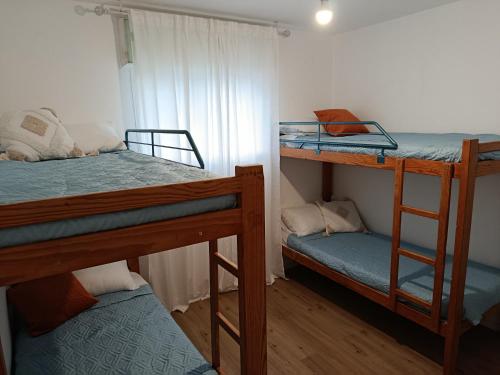 a room with two bunk beds and a window at Neoth Deshe 770 in Safed