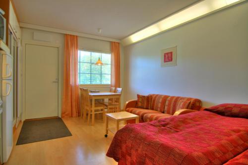 a living room with a couch and a table at Tahko Huoneistohotelli A in Tahkovuori