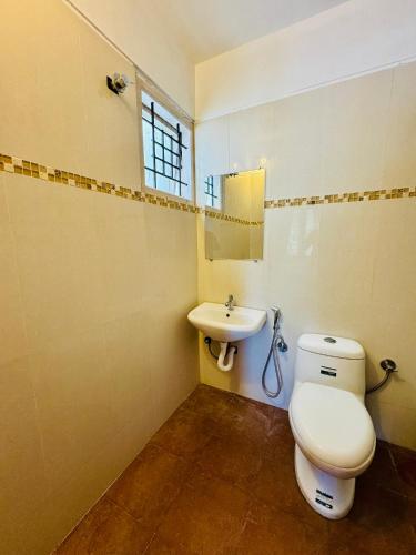 a bathroom with a toilet and a sink at Hotel SK Temple View in Tiruvannāmalai