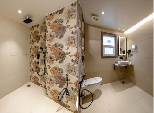 a bathroom with a shower and a toilet at Holiday Homez, City Centre with Free Airport & Train Station Pickup in New Delhi