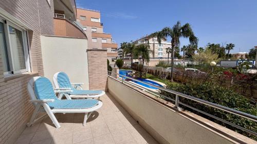 two chairs sitting on the balcony of a house at Residencial Ronda Mar in Denia