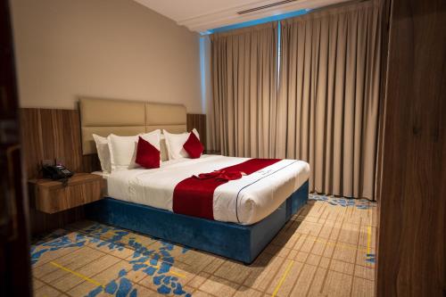 a bedroom with a bed with a red bow on it at Golden New Hira Serviced Apartments in Jeddah