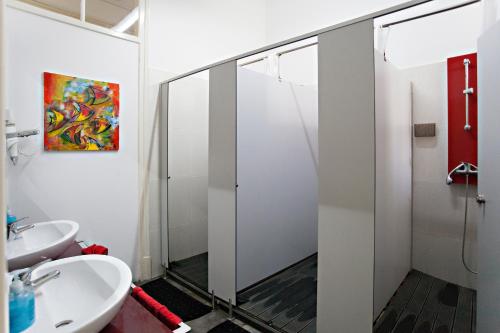 a bathroom with a shower and a sink at Baixa Terrace Hostel in Faro