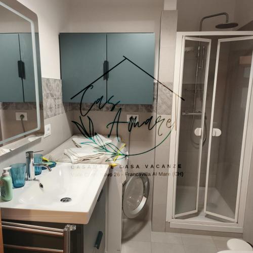 a bathroom with a shower and a sink and a mirror at CasAmare in Francavilla al Mare