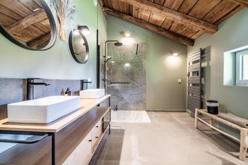 a bathroom with two sinks and a shower at Chalet Design Terre De Sapins in Mont-Saxonnex