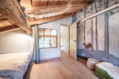 a bedroom with a mural of a dog on the wall at Chalet Design Terre De Sapins in Mont-Saxonnex
