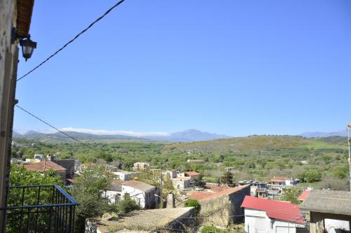 a view of a city with mountains in the background at Roukouneli Traditional Stone House - Terrace & BBQ in Arménoi
