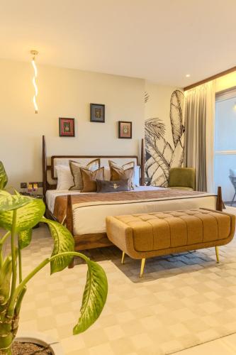 a bedroom with a large bed and a plant at Hotel Bawa Udaipur in Udaipur