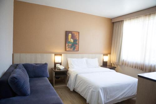 Postel nebo postele na pokoji v ubytování Hotel Palmeiras