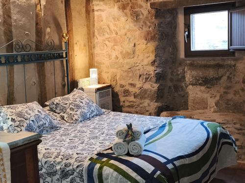 a bedroom with a bed with two towels on it at Casa Sorianna in Montenegro de Cameros
