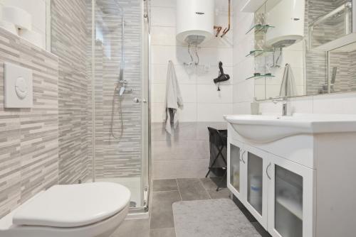 a bathroom with a toilet and a sink and a shower at House Molnar in Kočevje