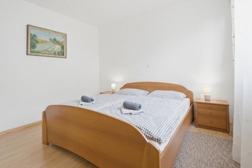 a bedroom with a bed and a picture on the wall at House Molnar in Kočevje
