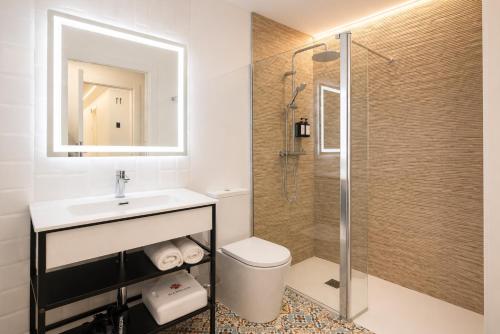 a bathroom with a toilet and a sink and a shower at Nova MSuites Valencia in Valencia