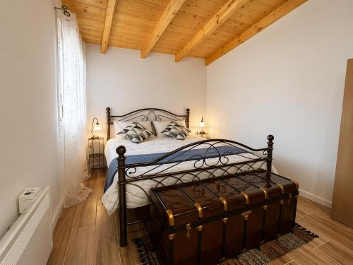 a bedroom with a bed and a wooden ceiling at Casa Plati 1 - Modern Escape with Pool & Garden in Platí